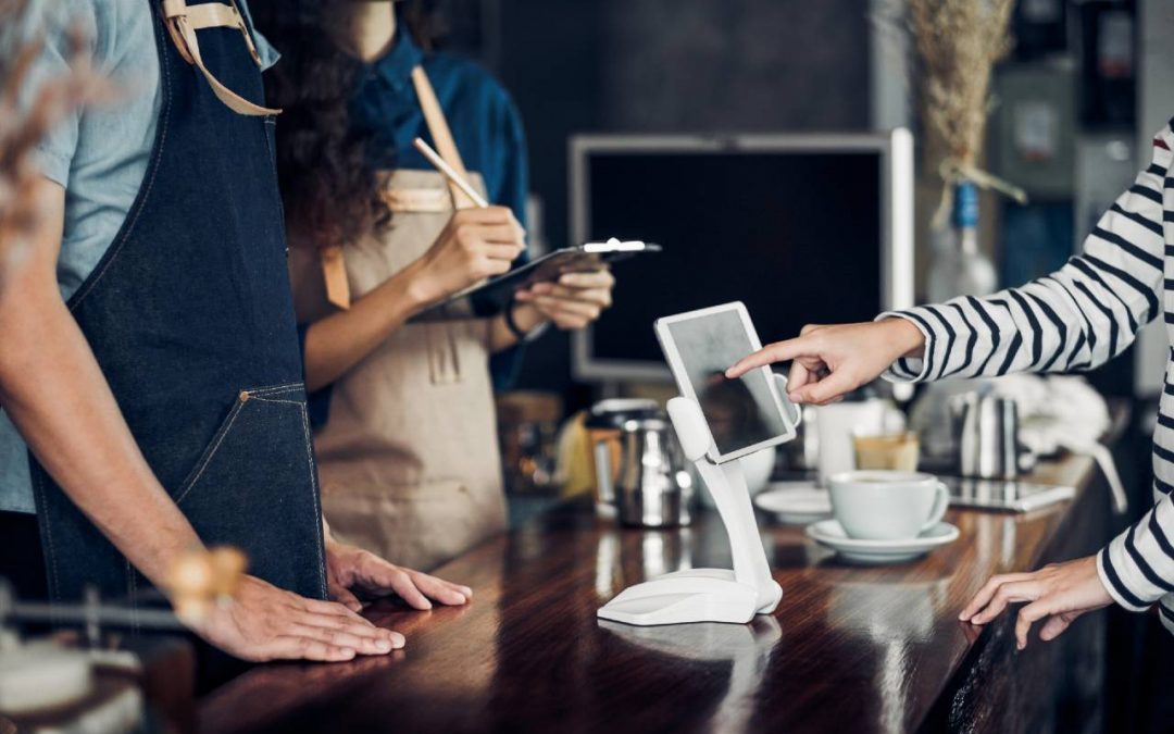 Lady using self service kiosk at cafe